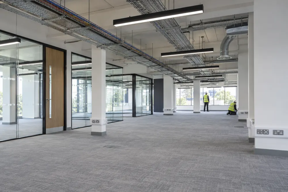 Commercial office fit-out with overhead cable containment and new work areas